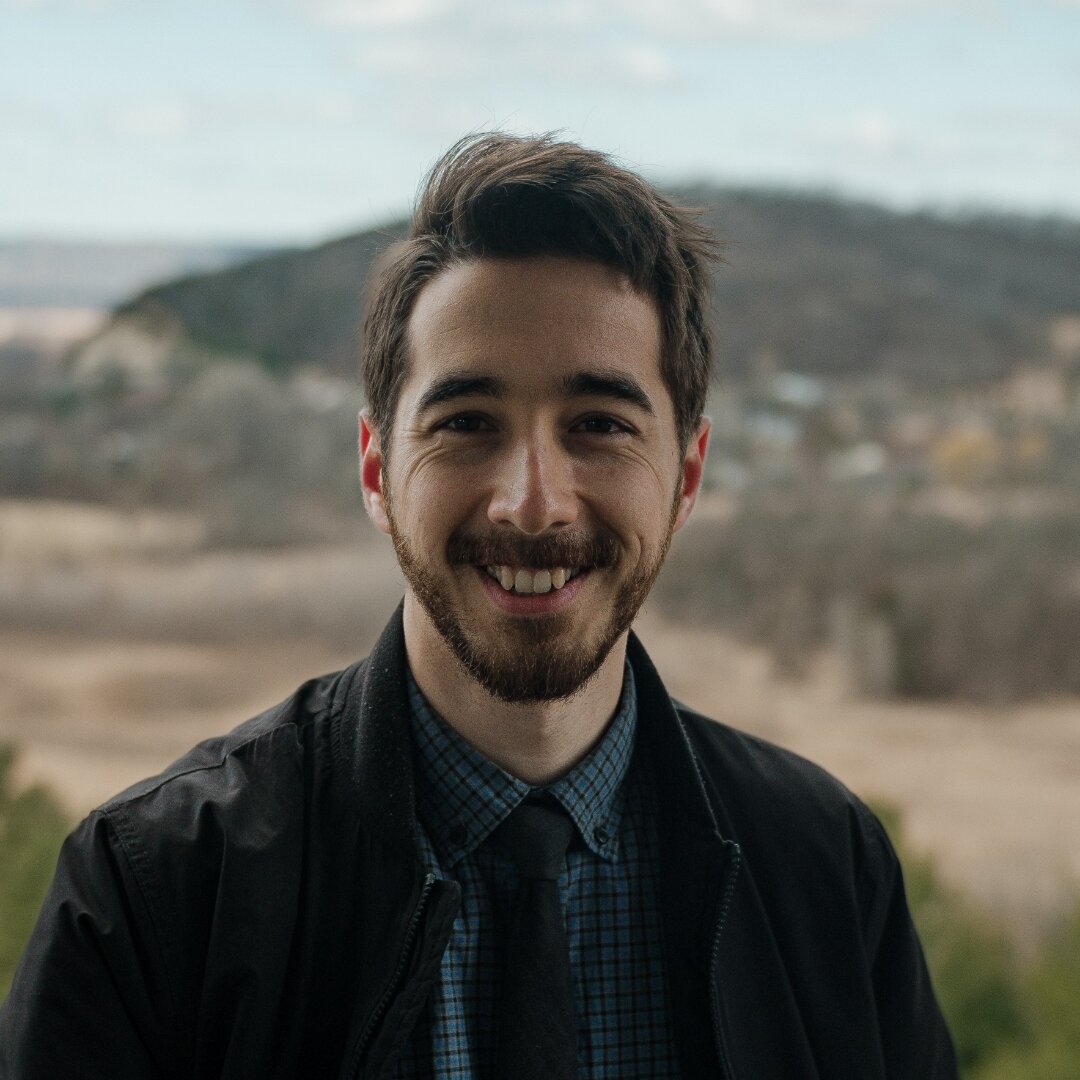 Portrait of Zachary Maxwell standing in front of the Wisconsin bluffs.